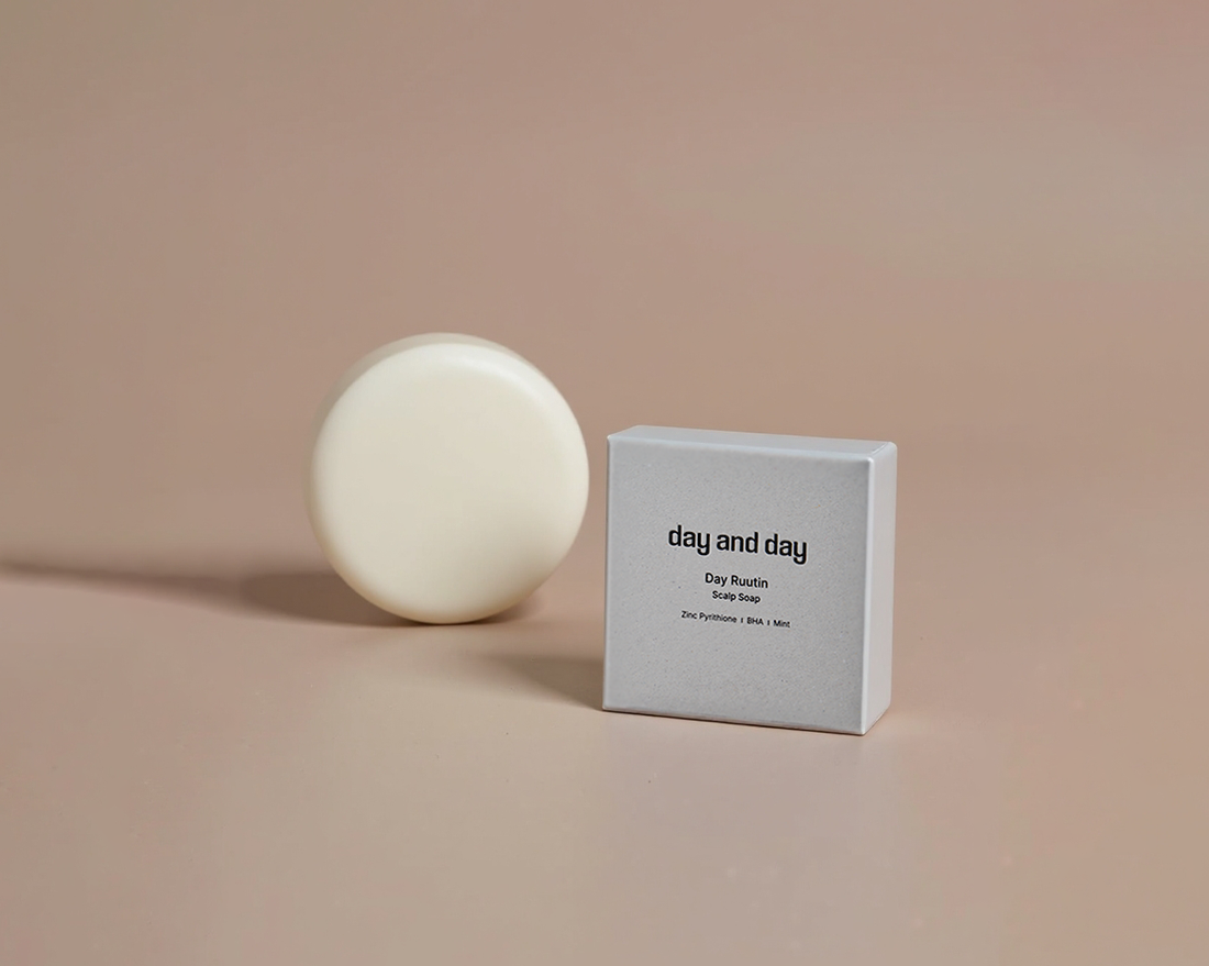 a seborheic shampoo bar and paper box with baige background made in Korea